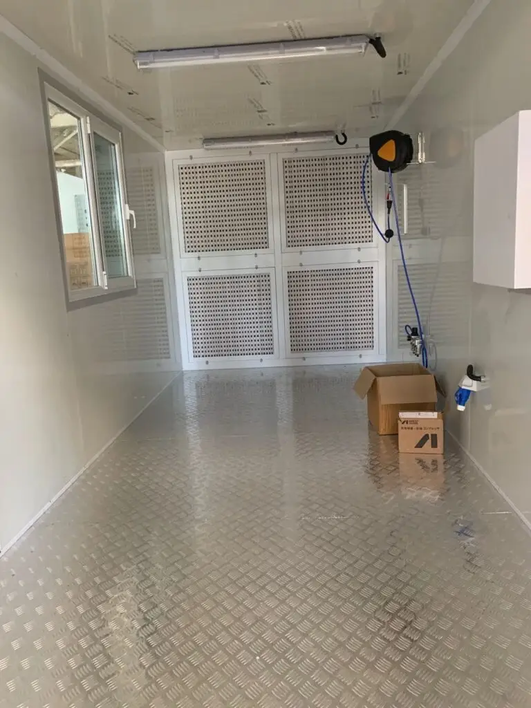 Inside a container paint booth