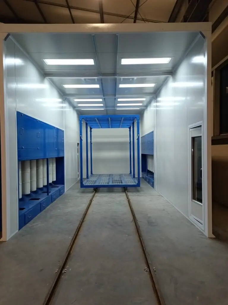 Powder coating booth interior with rail