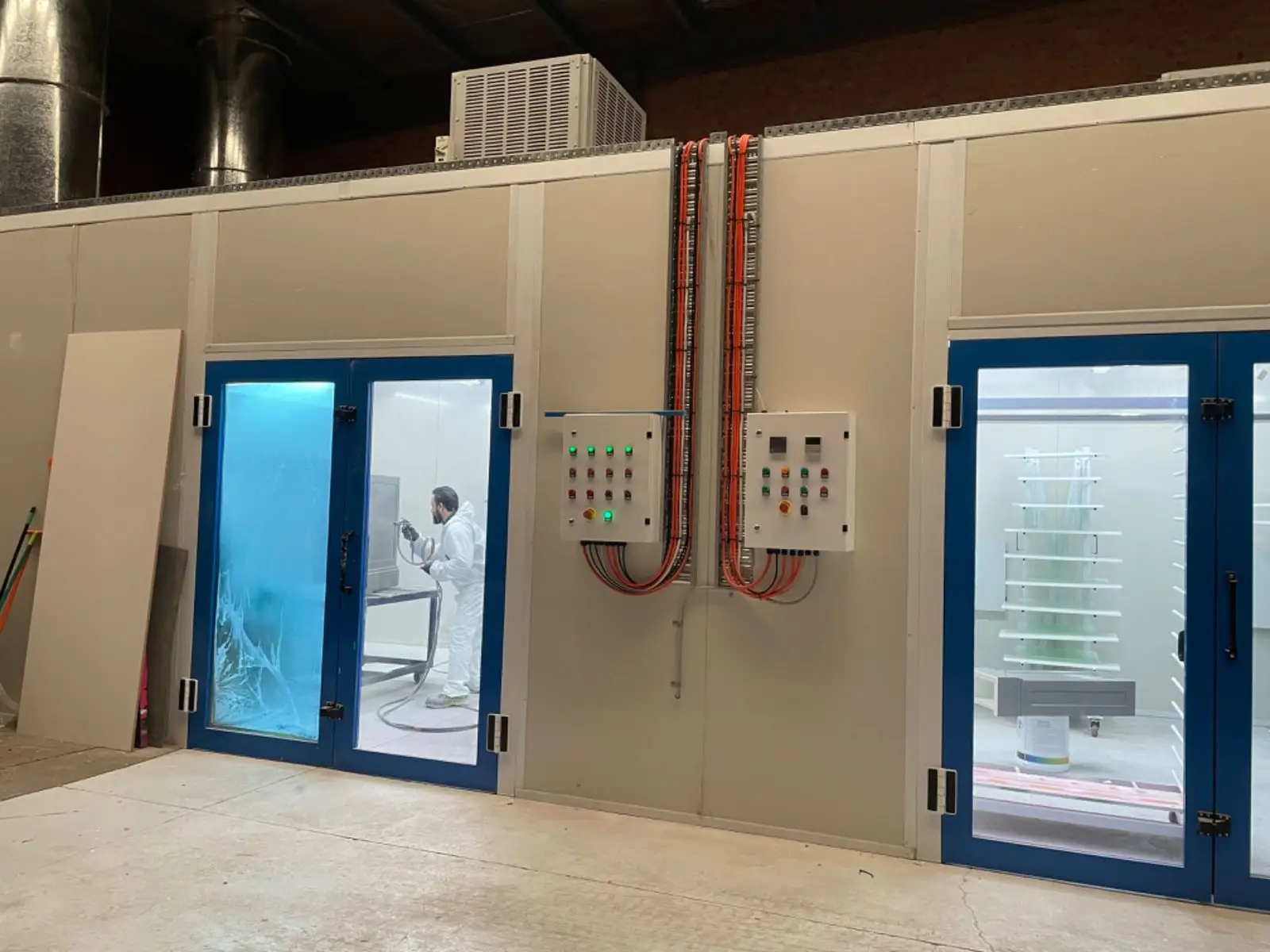 Spray booth with control boxes and glass doors